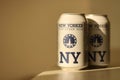 TERNOPIL, UKRAINE - JULY 18, 2022 Two cans of New Yorker fine lager beer with original logo and design on brown retro background