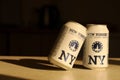 TERNOPIL, UKRAINE - JULY 18, 2022 Two cans of New Yorker fine lager beer with original logo and design on brown retro background