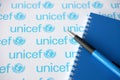 TERNOPIL, UKRAINE - MAY 2, 2022: Blue notepad and pen from UNICEF - United Nations programm that provides humanitarian and Royalty Free Stock Photo