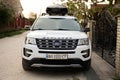 Ternopil, Ukraine -May, 2023: Ford Explorer family car with roof rack Thule Motion XXL box in ukrainian license plates.