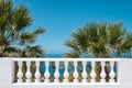 Terrace balluster with ocean view, blue sky and palm tree background