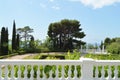 Terrace with balustrade and beautiful views of the Park with pine trees, cypress trees and columns on the background of