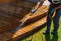 Terrace cleaning. Worker renovating a gray terrace