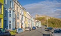 Terrace of colourful hotels on the sea front with Criccieth Castle in background in Criccieth, Gwynedd, Wales, UK Royalty Free Stock Photo