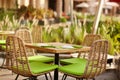 Terrace of a cozy cafe in green tones with wicker furniture under the open sky. Street cafe Royalty Free Stock Photo