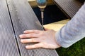 Terrace deck construction - man installing wpc composite decking boards Royalty Free Stock Photo