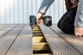 Terrace deck construction - man installing wpc composite decking boards Royalty Free Stock Photo