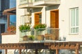 Terrace with flowering plants and trees on the balcony illuminated by the sun with wooden decor elements Royalty Free Stock Photo