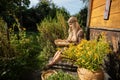 The young herbalist pours the stripped goldenrod flowers into a basket.