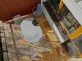 terrace by house.paving tiles brown and yellow. oval table,