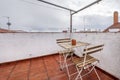 Terrace of a house with a wooden and metal table, matching chairs Royalty Free Stock Photo