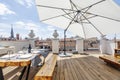 Terrace with large white fabric umbrella with wooden floors,