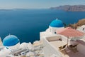 Terrace with nobody on two deck chairs in the greek island of Satorini with the best landscape of the Aegean sea and the Caldera Royalty Free Stock Photo