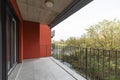 Terrace overlooking nature of apartment with red exterior walls