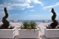 Terrace overlooking the sea, white balustrade, bench and boxwood