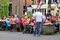 People have fun at a cosy terrace with Dutch flags, Kingsday (Koningsdag) in Baarn, Netherlands Royalty Free Stock Photo