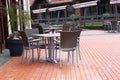 Terrace with rattan outdoor tables and chairs. Chairs and tables in outdoor restaurant in europen city. Patio in summer. Resort Royalty Free Stock Photo