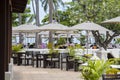 Terrace restaurant with umbrellas next to the beach. Thailand