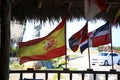 Terrace of a roadside restaurant with national flags, close up. Cuba island