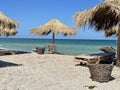 Beach in Vama Veche resort, with wooden sunbeds and reed umbrellas