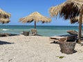 Beach in Vama Veche resort, with wooden sunbeds and reed umbrellas