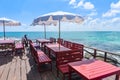 Terrace view sea with wooden table and chairs on the beach landscape nature with sunlight on umbrella - wooden balcony view Royalty Free Stock Photo