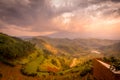 Terraced fields at sunset in the valley with Virunga Volcanoes in background from Kisoro in colorful early morning,. Kisoro Distri