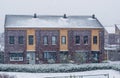 Terraced houses on a cold and snowy winter day, modern dutch architecture, snowfall in a small dutch village Royalty Free Stock Photo