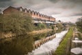 Terraced style modern houses on the side of the Leeds Liverpool canal between Wigan and Appley Bridge Royalty Free Stock Photo