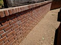 terraces of brick walls in several levels with a massive wooden bench from