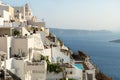 Terraces and church lightened by last sun in Fira, Santorini, Greece