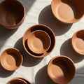 Terracotta bowls arranged on a light fabric surface. The bowls vary in size and are Royalty Free Stock Photo