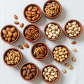 Terracotta bowls filled with assorted nuts arranged on a white tablecloth. Varieties Royalty Free Stock Photo