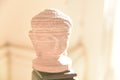 Terracotta Buddha head statue on a standing post