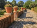 Terracotta flower pots arrayed on brick wall in Parc de Bercy, Paris, France