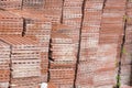 Terracotta roof tiles stacked ready for use with a symmetrical pattern Royalty Free Stock Photo