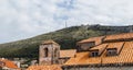 Terracotta rooftops beneath Srd Hill