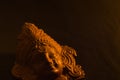 terracotta sculpture of face of goddess Durga for Durga Puja festival in west bengal india. shot against black background in