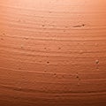 Terracotta surface with a rough texture, featuring small holes and ridges. The earthy Royalty Free Stock Photo