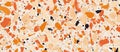 Terrazzo floor featuring orange and black stones in a intricate pattern Royalty Free Stock Photo