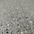 Terrazzo flooring with a polished finish, featuring a speckled pattern of black, white, Royalty Free Stock Photo