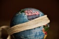 Terrestrial globe with a piece of cloth tied around it