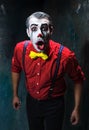 Terrible clown and Halloween theme: Crazy red clown in a shirt with suspenders