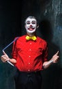 Terrible clown and Halloween theme: Crazy red clown in a shirt with suspenders