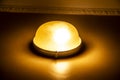 A Terrible light on the wall. The old lamp on the wall with yellow light Royalty Free Stock Photo