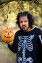 Terrible man. Human zombies holding a pumpkin in her hands. Symbol of the holiday Halloween.