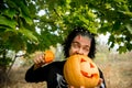 Terrible man. Human zombies holding a pumpkin in her hands. Symbol of the holiday Halloween.