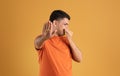 Terrible smell concept. Brazilian man closing his nose and gesturing STOP, repulsed by unpleasant odor or stinky perfume Royalty Free Stock Photo