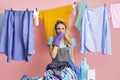 Housewife closes nose in front of heap of dirty clothes