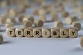 Terribly - cube with letters, sign with wooden cubes Royalty Free Stock Photo